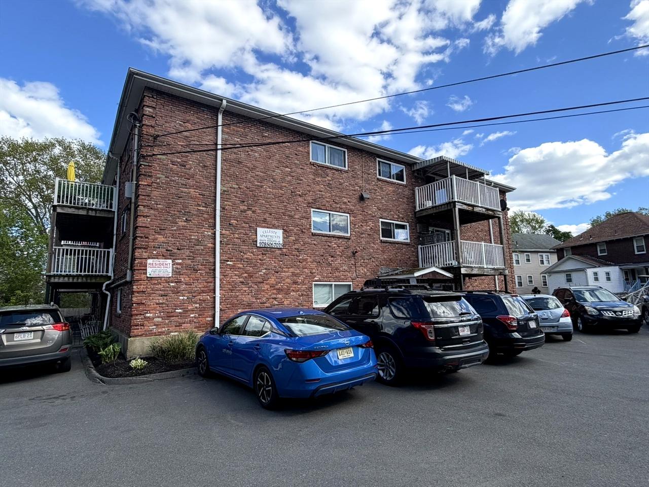 Side elevation of 38 Clapp Street with on-site parking lot