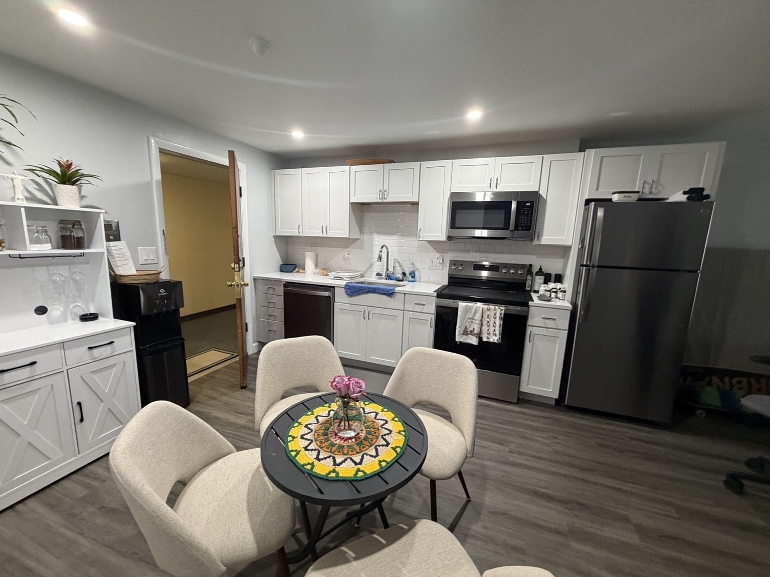 Renovated apartment kitchen with white shaker cabinets and a dining nook