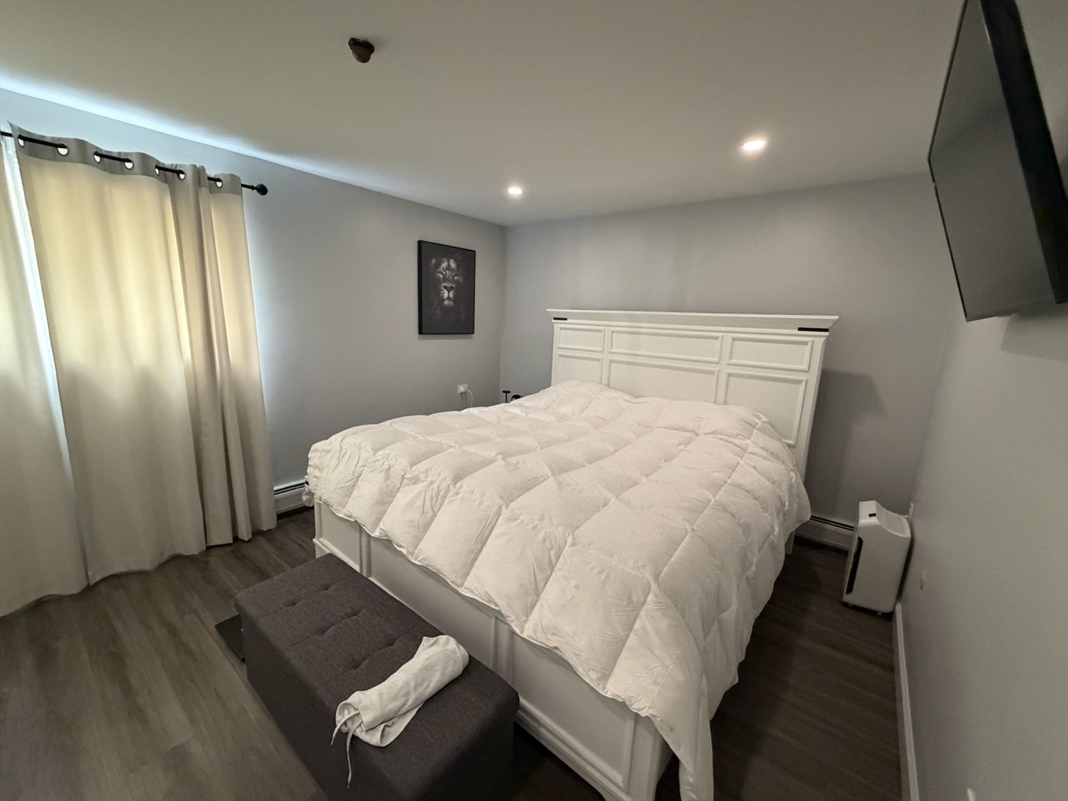 Renovated apartment bedroom with plank flooring