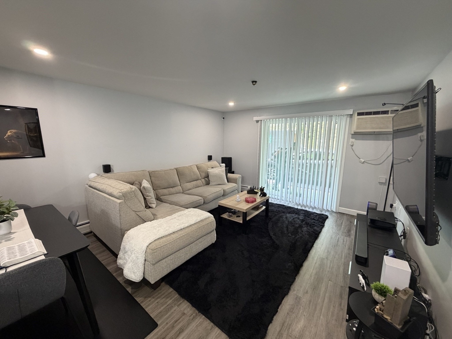 Renovated apartment living room with a light sofa and slider