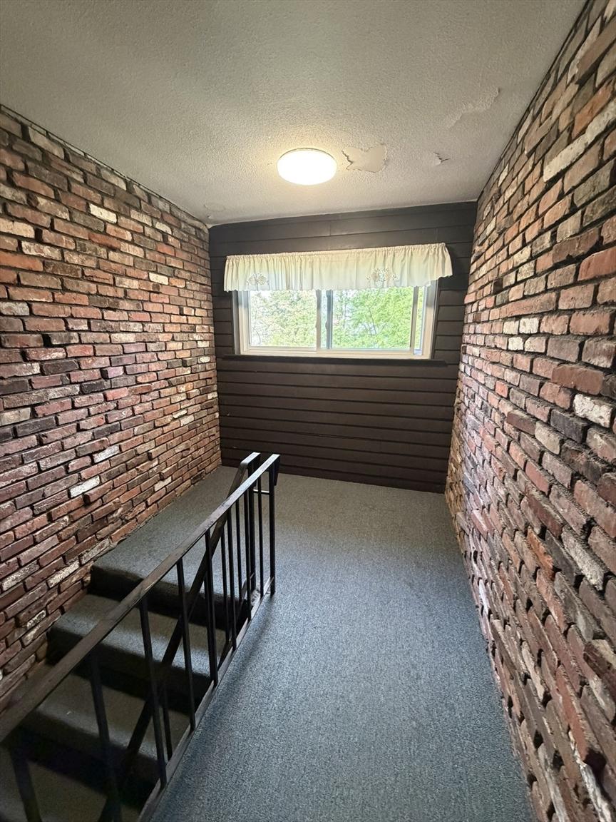 Interior stairwell with exposed brick at 38 Clapp Street
